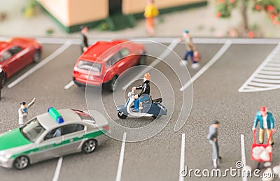 Busy urban life with miniature people and automobiles on a busy street