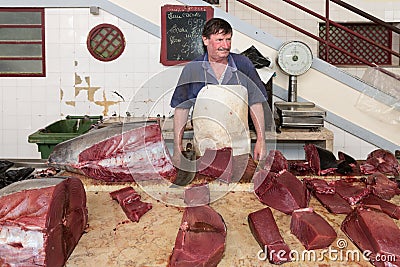 Butcher at the fish market of Funchal, Madeira Island