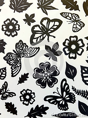 Butterflies, leaves and flowers pattern. Paper cutting.