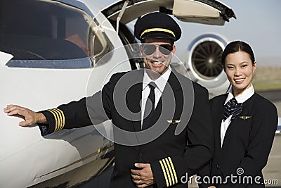 Cabin Crew Members By An Aircraft