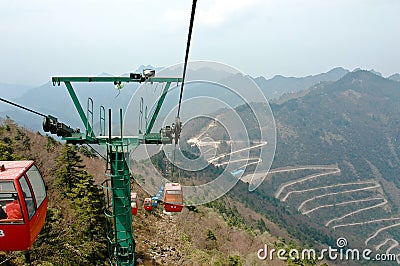 Cable car mast standing in the mountain forest.