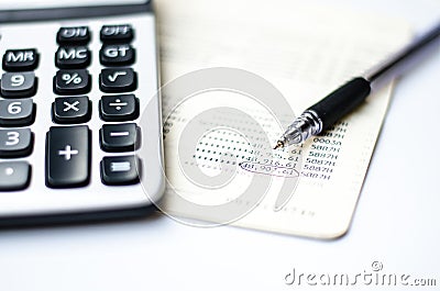 Calculations and account book and pen