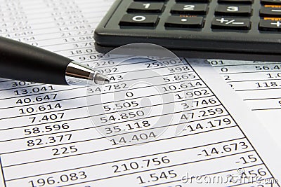 Calculator and pen on financial papers