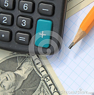 Calculator, pen and pad at dollars
