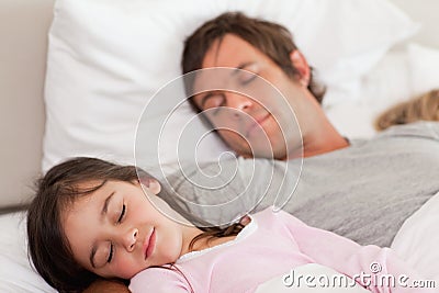 Calm father sleeping with his daughter