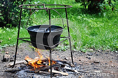 Campfire cooking in cauldron
