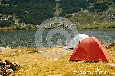 Camping tents near a mountain lake