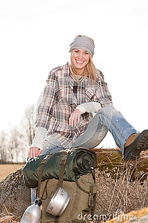 Camping young woman in countryside backpack relax