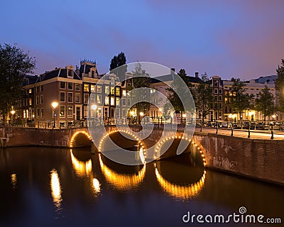 Canal With Bridge In Amsterdam At Night