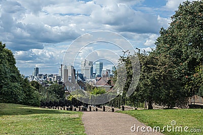 Canary Wharf in London under dramatic sky seen from Greenwich Park.