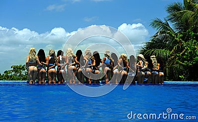 CANCUN, MEXICO - MAY 05: Models pose by the edge of pool for white t-shirt project