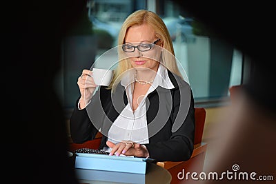 Candid photo of a middle-aged blond businesswoman