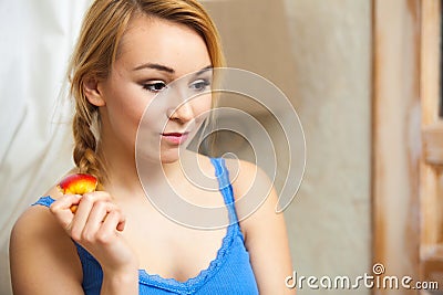 Candid portrait pensive woman teenage girl eating apple fruit