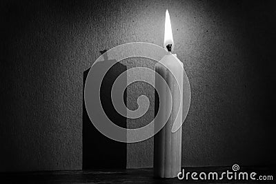 Candle in darkness with spotlight making shadow texture conversi