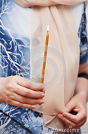 Candle in a hand of the woman