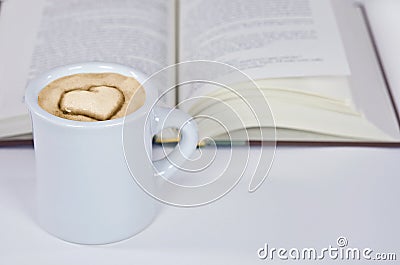 Cappuccino with heart design and book