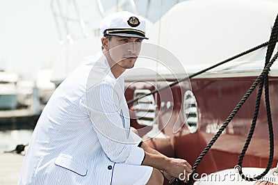 Captain holding rope of the yacht