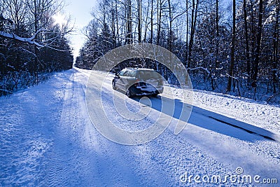 Car on a dangerous road covered with snow and ice.