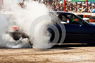 Car is drifting in front of crowd