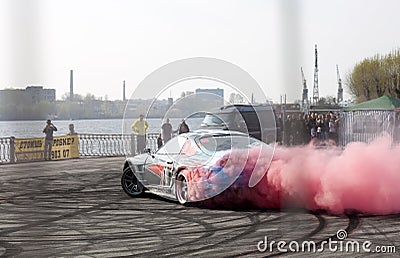 Car drifting with red smoke at Royal Auto Show