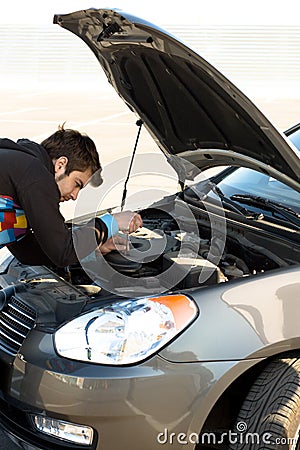 Car driver examining the car s engine