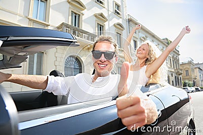 Car driver happy giving thumbs up - driving couple