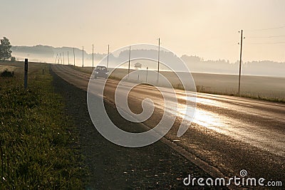 Car driving along foggy road