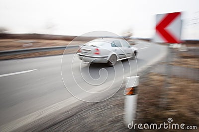 Car driving fast through a sharp turn