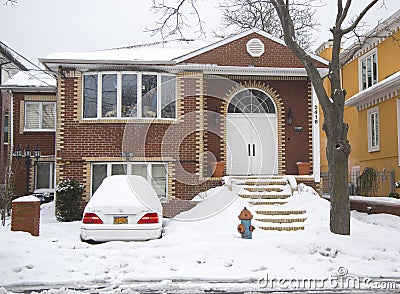 Car and house under snow after massive winter storms strikes Northeast