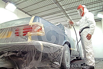 Car mechanic and paint spray