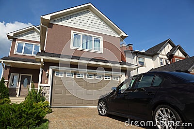Car near garage of new two-storied cottage