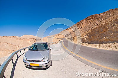 Car on the road in the desert