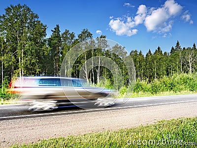 Car speeding on country highway,motion blur