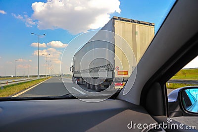 Car speeding over a truck on a highway