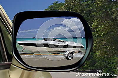 Car & speedy boat on paradise beach.