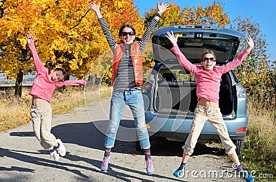 Car trip on autumn family vacation, happy mother and kids travel