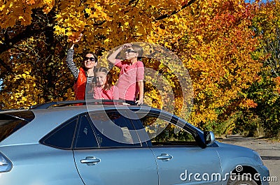 Car trip on autumn family vacation, happy mother and kids travel