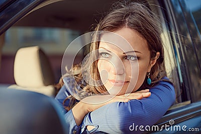 Car woman on road trip looking out of window. Having rest on sun
