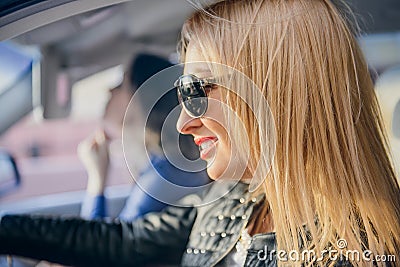 Car woman on road trip looking on the road