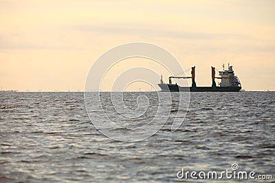 Cargo container ship sailing in still water