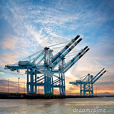 Cargo sea port. Cranes in the port. Sunset.