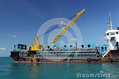 Cargo ship drop container in the sea for artificial reef