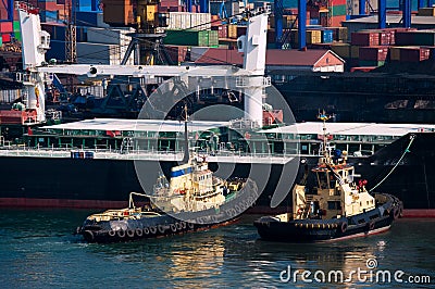 Cargo ship and tug boat in port