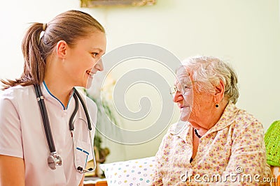 Caring doctor with elderly woman