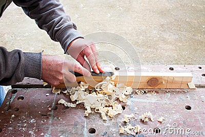 Carpenter chiselling wood