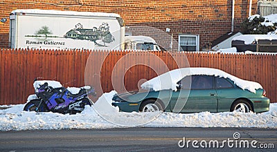 Cars and motorcycle under snow in Brooklyn after massive winter storms strikes Northeast