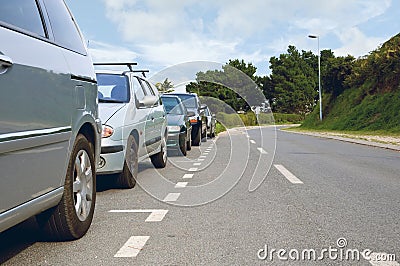 Cars parked on the side of the empty road