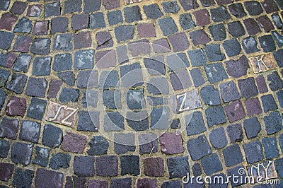 Carved letters in grey paving stones