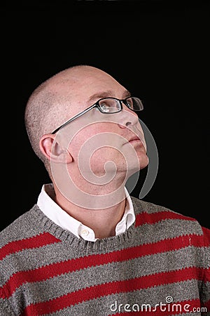 Casual bald man looking up