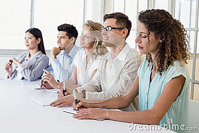 Casual business team listening during meeting